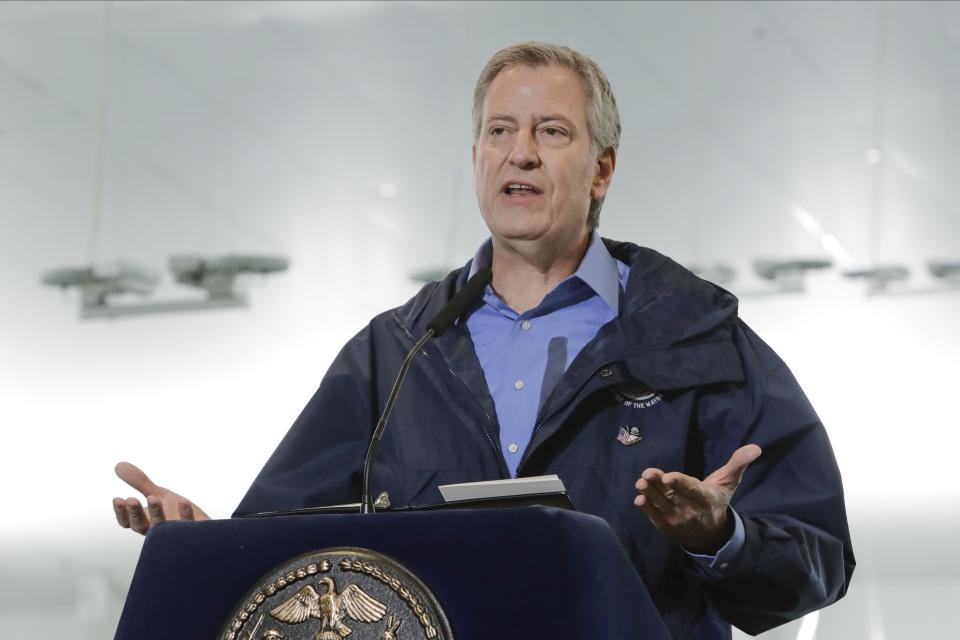 FILE - In this March 31, 2020 file photo, New York City Mayor Bill de Blasio speaks at the USTA Indoor Training Center where a 350-bed temporary hospital will be built in New York. De Blasio is calling for a national enlistment program for doctors and nurses, on Friday, April 3, to handle an expected surge in coronavirus cases in New York and other places around the country. (AP Photo/Frank Franklin II, File)