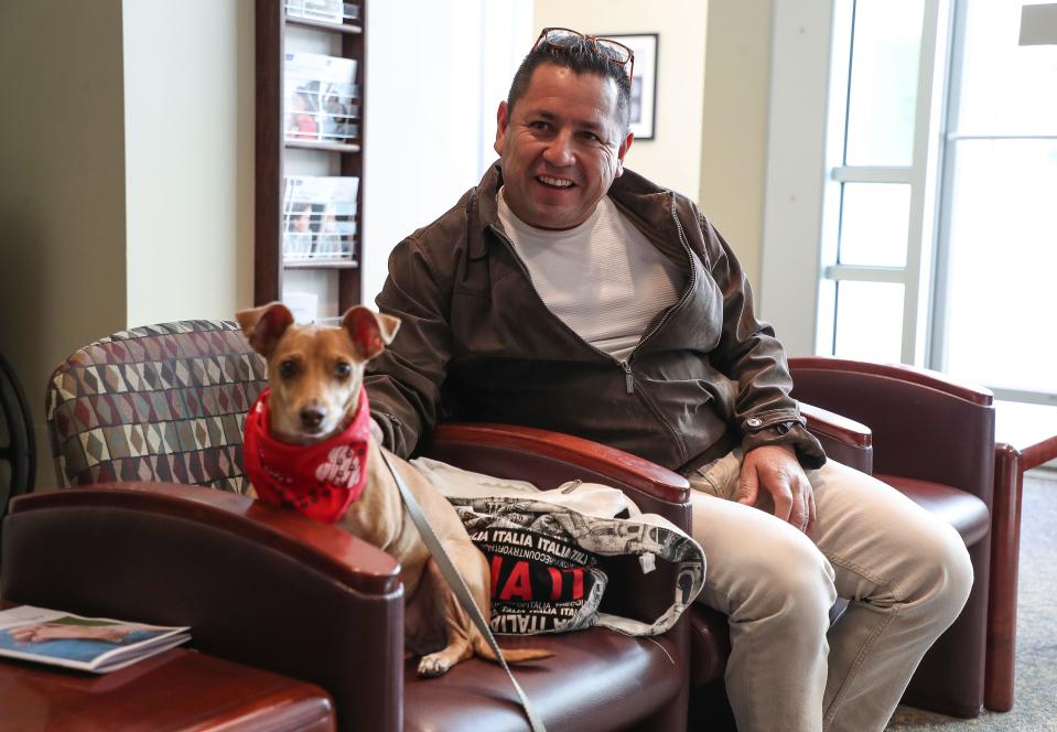 Alejandro Rivera hangs out with the dog Ernie Banks at the Desert Care Network's Comprehensive Cancer Center at Desert Regional Medical Center in Palm Springs on Nov. 17. Ernie volunteers here once a week with his human guardian, Winston Gieseke.