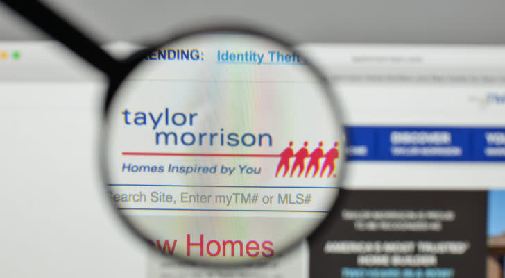 the taylor morrison logo displayed on a web browser and magnified by a magnifying glass