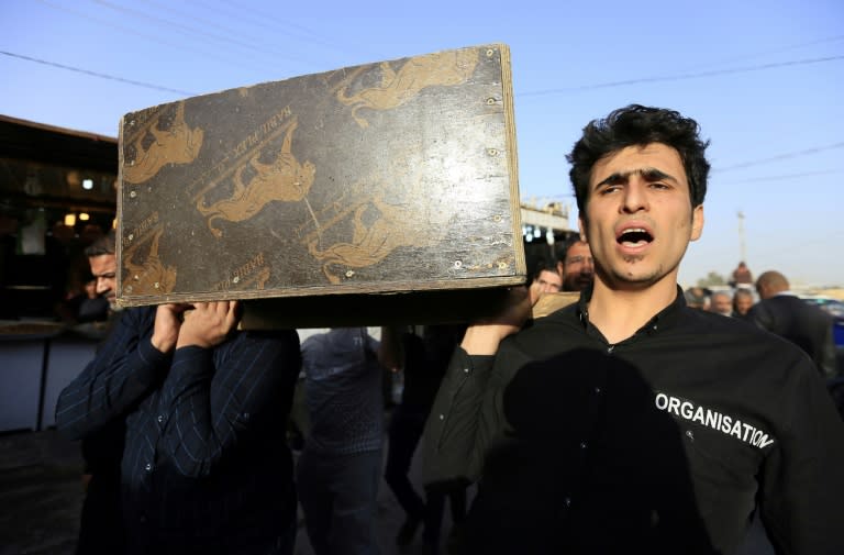 Iraqis carry the coffin of a victim of the Baghdad blasts during a funeral in the holy city of Najaf on January 15, 2018