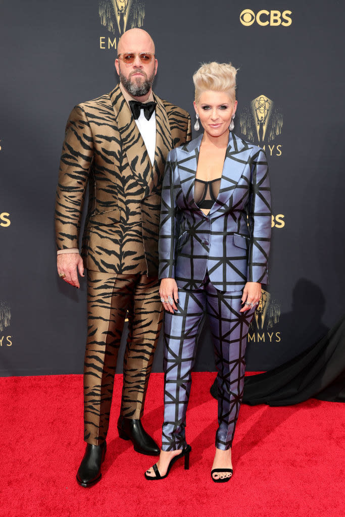 Chris Sullivan wears a tiger striped suit and Rachel Sullivan wears a dark colored suit with stripes