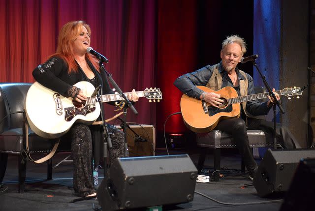 <p>Jason Kempin/Getty </p> Wynonna Judd and Cactus Moser perform at the Country Music Hall of Fame and Museum in 2019