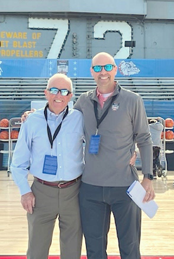 Bartlesville resident Bob Pomeroy, left, poses with son Scott on the USS Abraham Lincoln aircraft carrier docked in San Diego, Calif., during preparation for the 2022 Armed Forces Classic basketball game, which Scott oversaw for ESPN.