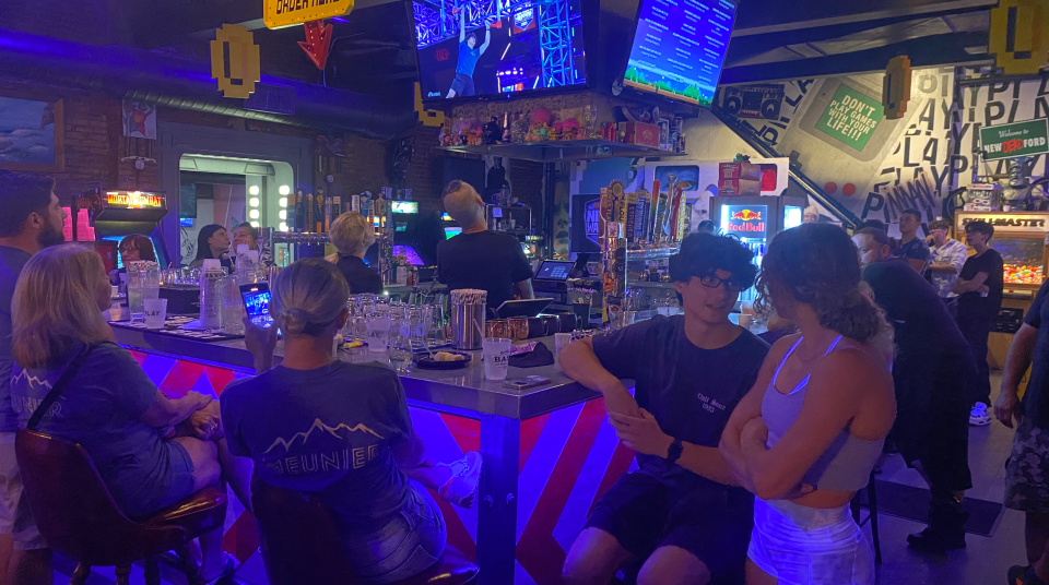At Play Arcade in New Bedford Monday night, Noah Meunier, left, watches his time on the American Ninja Warrior course on the finale of the show with his girlfriend, Addy Herman.