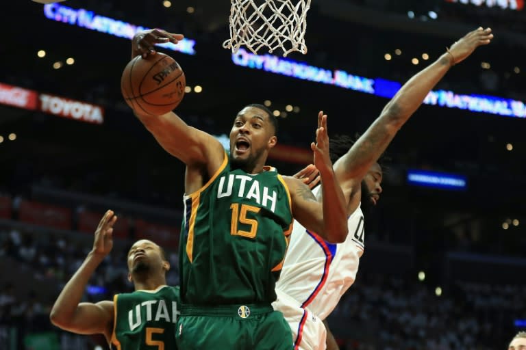 Derrick Favors (C) of the Utah Jazz battles DeAndre Jordan of the Los Angeles Clippers for a rebound on April 30, 2017