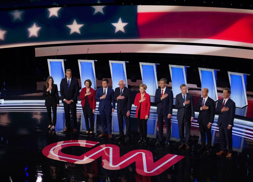 Candidates on stage during the National Anthem before the start of the first night of the Democratic presidential debates at the Fox Theatre in Detroit on  July 30, 2019.