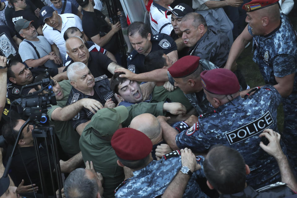 Police blocked the way to protesters during a rally against Prime Minister Nikol Pashinyan in Yerevan, Armenia, Wednesday, June 12, 2024. (Hayk Baghdasaryan/Photolure via AP)