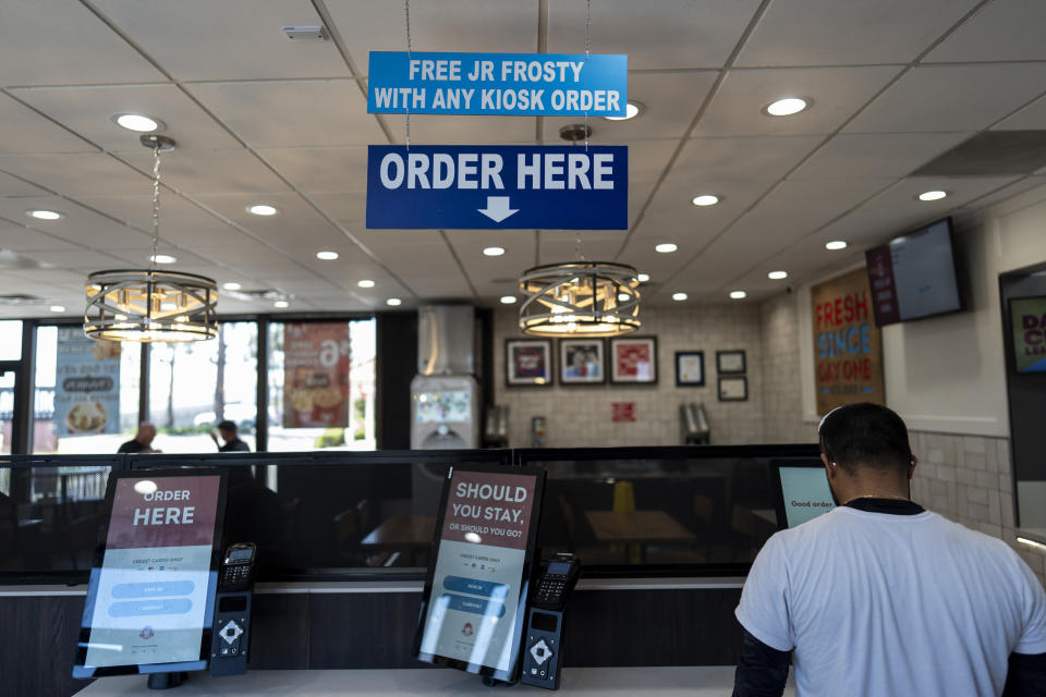 A customer uses a self-order kiosk to order at a Wendy's restaurant owned by Lawrence Cheng and his family in Fountain Valley, Calif., Thursday, June 20, 2024. (AP Photo/Jae C. Hong)