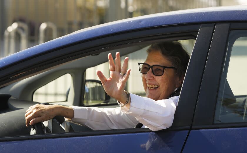 LOS ANGELES, CA - APRIL 01, 2020 LAUSD school board member Jackie Goldberg, at 75 years of age thanks workers distributing food as she is visiting South East High School in South Gate Wednesday morning April 1, 2020 as she is driving around from school to school in Southeast L.A. County to see how things are going. The campuses are closed because of the coronavirus Covid 19, but 63 schools are being used to hand out computers. In addition, students are picking up computers and internet hotspots from schools as well as homework packets. (Al Seib / Los Angeles Times)