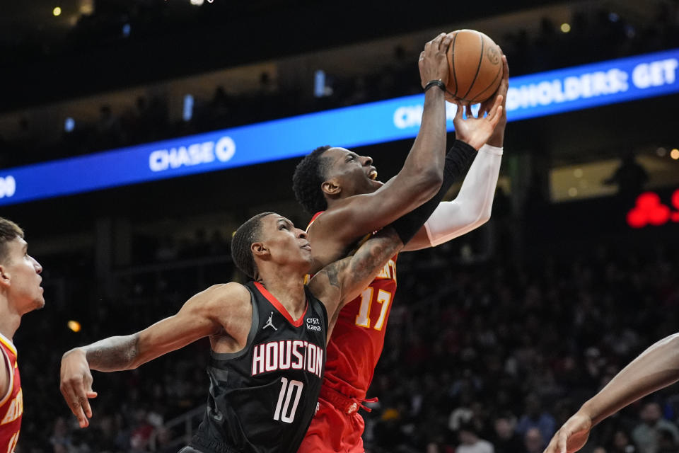 Atlanta Hawks forward Onyeka Okongwu (17) goes in for a shot as Houston Rockets forward Jabari Smith Jr. (10) defends during the second half of an NBA basketball game Saturday, Feb. 10, 2024, in Atlanta. (AP Photo/John Bazemore)