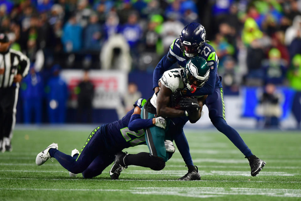 SEATTLE, WASHINGTON – DECEMBER 18: A.J. Brown #11 of the Philadelphia Eagles catches a pass against Riq Woolen #27 and <a class="link " href="https://sports.yahoo.com/nfl/players/40056/" data-i13n="sec:content-canvas;subsec:anchor_text;elm:context_link" data-ylk="slk:Devon Witherspoon;sec:content-canvas;subsec:anchor_text;elm:context_link;itc:0">Devon Witherspoon</a> #21 of the Seattle Seahawks at Lumen Field on December 18, 2023 in Seattle, Washington. (Photo by Jane Gershovich/Getty Images)
