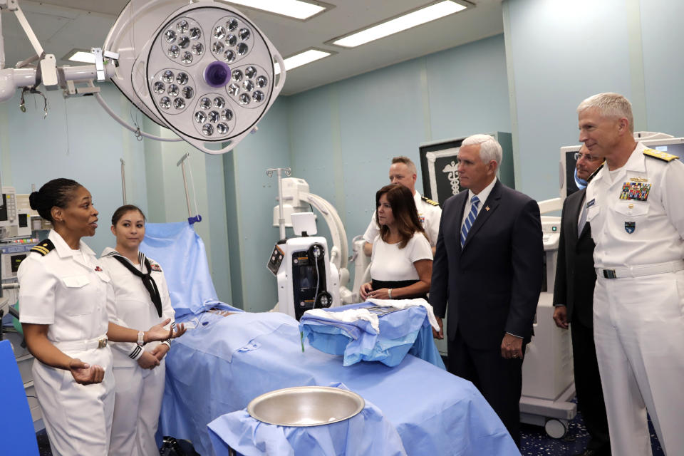 Vice President Mike Pence and his wife Karen tour a surgery room on the USNS Comfort, Tuesday, June 18, 2019, in Miami. The hospital ship is scheduled to embark on a five-month medical assistance mission to Latin America and the Caribbean, including several countries struggling to absorb migrants from crisis-wracked Venezuela. At right is Adm. Craig Faller, commander of U.S. Southern Command. (AP Photo/Lynne Sladky)