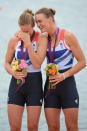 WINDSOR, ENGLAND - AUGUST 01: (L-R) Helen Glover and Heather Stanning of Great Britain celebrate with their gold medals during the medal ceremony after the Women's Pair Final A on Day 5 of the London 2012 Olympic Games at Eton Dorney on August 1, 2012 in Windsor, England. Australia won silver and New Zealand won bronze. (Photo by Harry How/Getty Images)