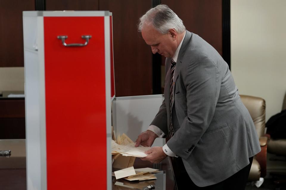 Victor Herlinsky opens the first of three voting boxes just before counting began, at the International Brotherhood of Electrical Workers Hall, Local 164, Monday, March 4, 2024, in Paramus.
