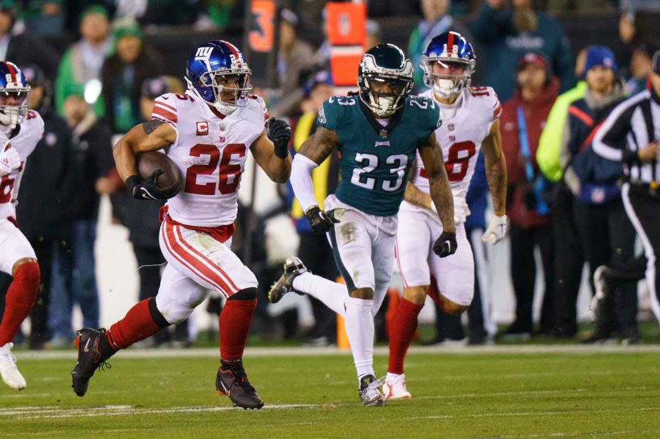 New York Giants running back Saquon Barkley (26) runs with the ball during the NFL divisional round playoff football game against the Philadelphia Eagles, Saturday, Jan. 21, 2023, in Philadelphia.