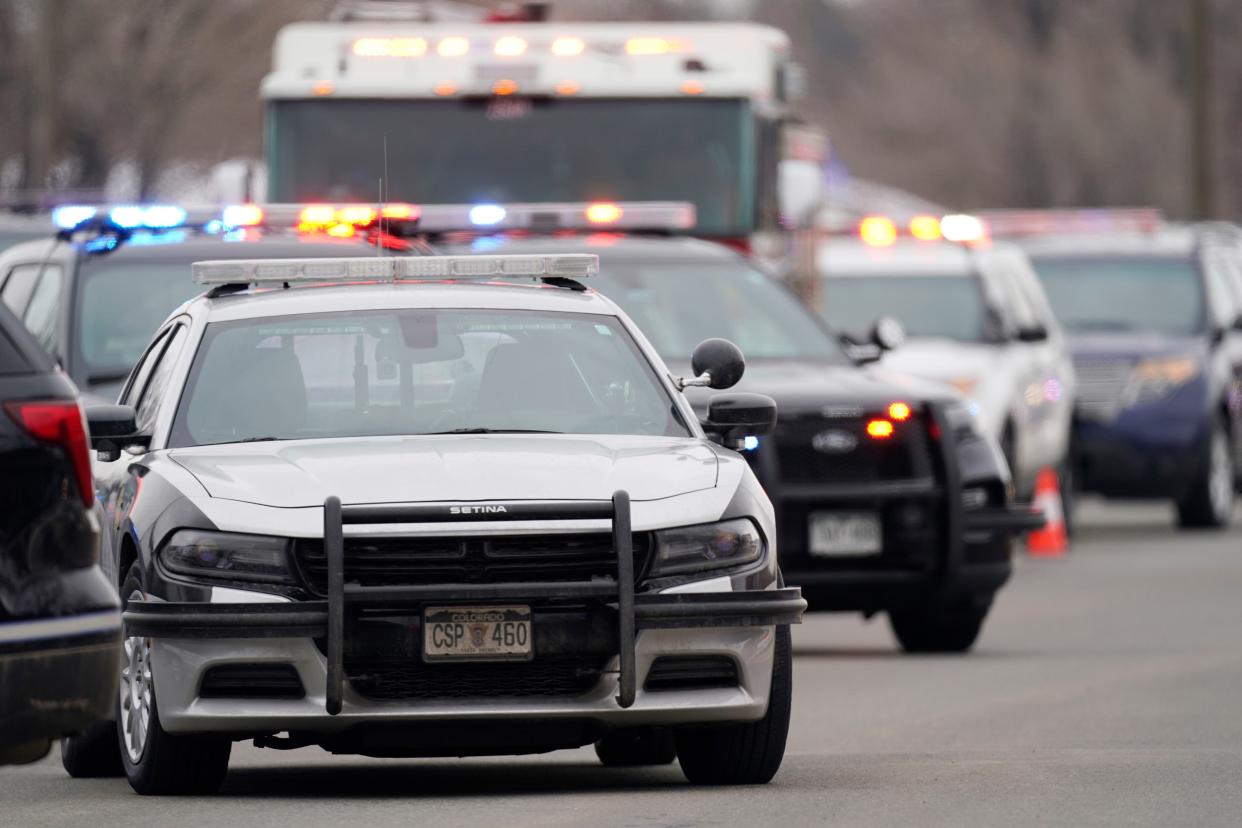 Police cars are parked outside a King Soopers grocery store where a shooting took place Monday, March 22, 2021, in Boulder, Colo.