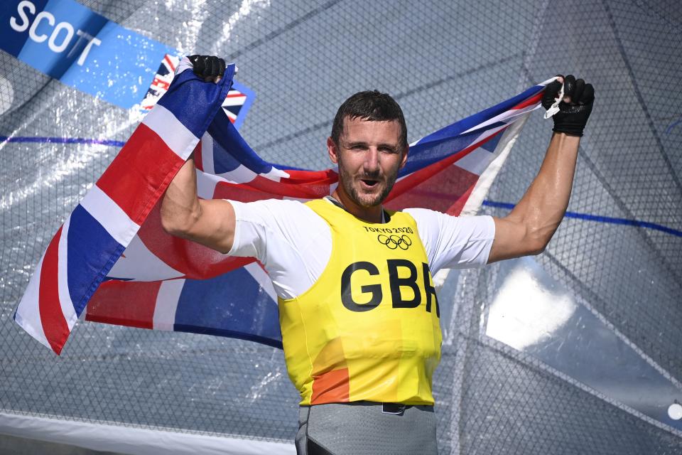 Great Britain's Giles Scott celebrates after the men's one-person dinghy (heavyweight) finn race during the Tokyo 2020 Olympic Games sailing competition at the Enoshima Yacht Harbour in Fujisawa, Kanagawa Prefecture, Japan, on August 3, 2021. (Photo by Olivier MORIN / AFP) (Photo by OLIVIER MORIN/AFP via Getty Images)