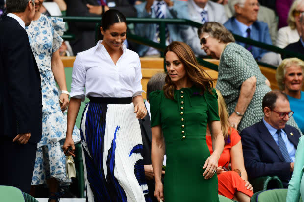 Meghan Markle, Duchess of Sussex, in a Hugo Boss skirt and Kate Middleton, Duchess of Cambridge, in a Dolce & Gabbana Dress <em>at </em><em>the Wimbledon women's singles final in London, England. Photo: Shaun Botterill/Getty Images</em>