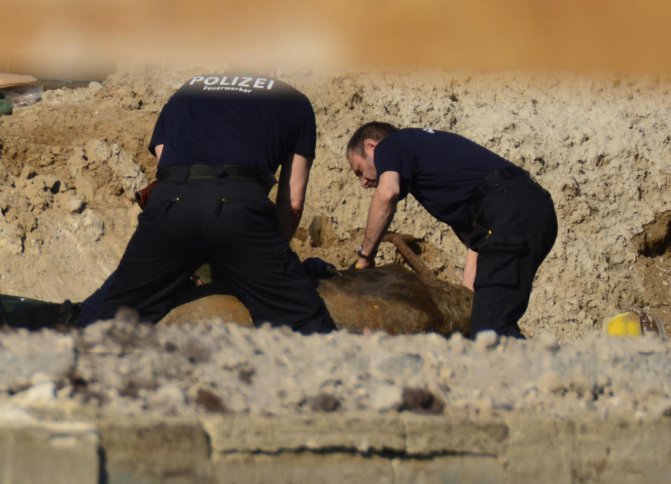 Police were seen examining the bomb (AP)