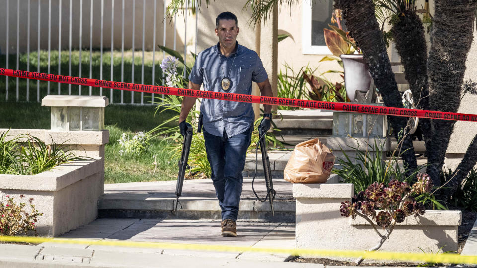 FILE - Investigators remove firearms from a house in the 8500 block of E. Canyon Vista Dr. in Anaheim, Calif., on Aug. 4, 2023. A Southern California judge was charged Friday, Aug. 11, 2023, with murder in the shooting death of his wife and 47 weapons were seized from the house, authorities said. Orange County Superior Court Judge Jeffrey Ferguson, 72, was arrested last week after his adult son called 911 to report his mother, Sheryl Ferguson, had been shot at the family's home in the upscale neighborhood of Anaheim Hills, the district attorney's office said in a statement. (Paul Bersebach/The Orange County Register via AP, File)