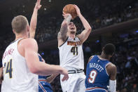 Denver Nuggets forward Juan Hernangomez (41) goes to the basket past New York Knicks forward RJ Barrett (9) during the first half of an NBA basketball game Thursday, Dec. 5, 2019, at Madison Square Garden in New York. (AP Photo/Mary Altaffer)