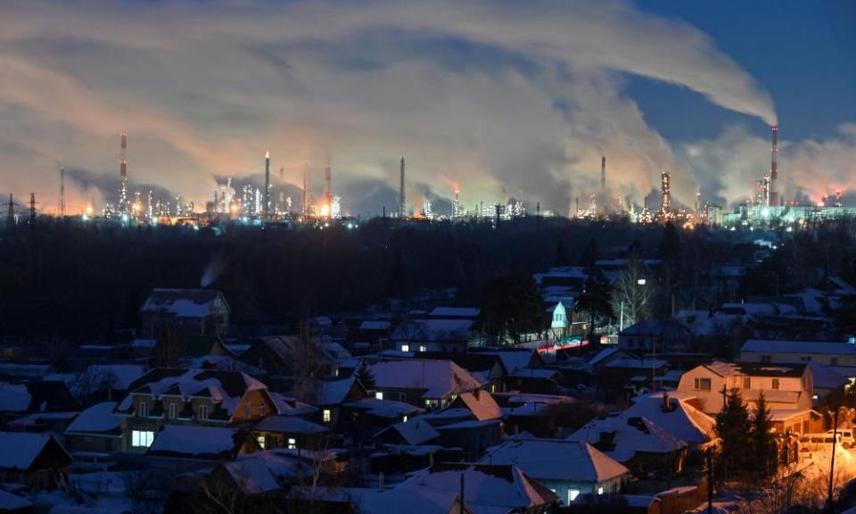 Flue gas and steam rise out of chimneys and smokestacks of an oil refinery during sunset on a frosty day in the Siberian city of Omsk, Russia, 8 February 2023