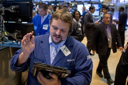 Traders work on the floor of the New York Stock Exchange July 28, 2015. REUTERS/Brendan McDermid