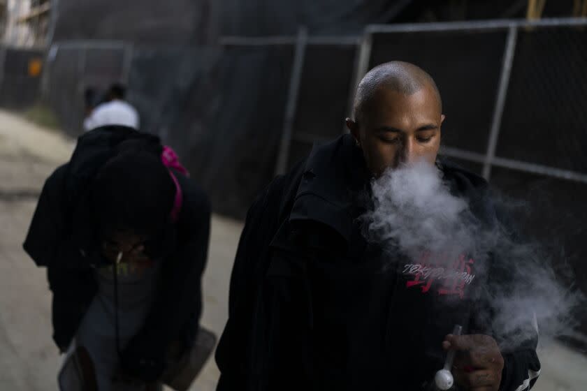 Armando Rivera, 33, smokes fentanyl mixed with methamphetamine in an alley in Los Angeles, Thursday, Aug.18, 2022. Use of fentanyl, a powerful synthetic opioid that is cheap to produce and is often sold as is or laced in other drugs, has exploded. Because it's 50 times more potent than heroin, even a small dose can be fatal. It has quickly become the deadliest drug in the nation, according to the Drug Enforcement Administration. (AP Photo/Jae C. Hong)