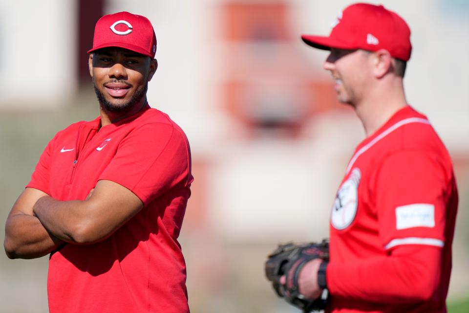 Cincinnati Reds starting pitcher Hunter Greene (21) smiles while talking to a teammate during spring training workouts, Friday, Feb. 16, 2024, at the team’s spring training facility in Goodyear, Ariz.