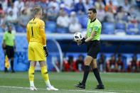 <p>Referee Ghead Grisha from Egypt hurries England goalkeeper Jordan Pickford during the group G match </p>