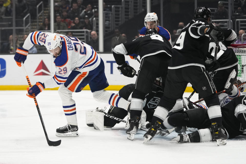 Edmonton Oilers' Leon Draisaitl (29) moves the puck as Los Angeles Kings players are tangled up around the net during the first period of an NHL hockey game Monday, Jan. 9, 2023, in Los Angeles. (AP Photo/Jae C. Hong)
