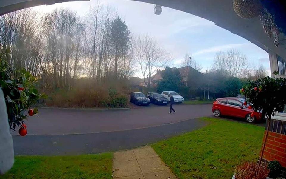 Olly Stephens checks his phone after leaving his home for the final time