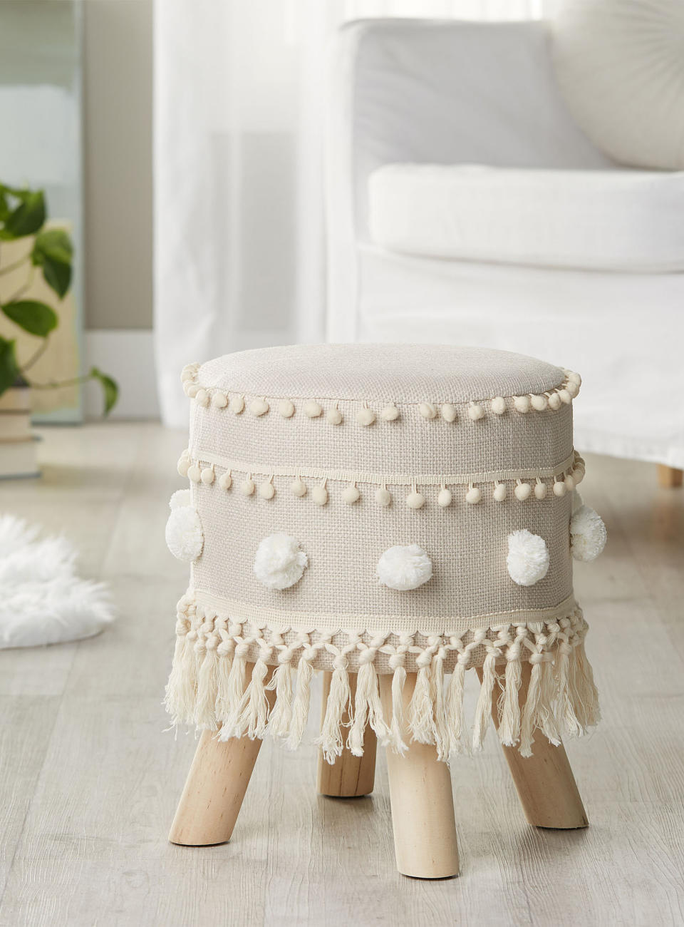 Fringe and pompom stool in cream with wooden legs