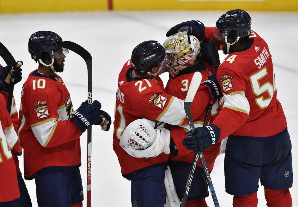 Florida Panthers center Nick Cousins (21) gets up close to goaltender Alex Lyon after beating the Buffalo Sabres 2-1 during an NHL hockey game, Tuesday, April 4, 2023, in Sunrise, Fla. (AP Photo/Michael Laughlin)