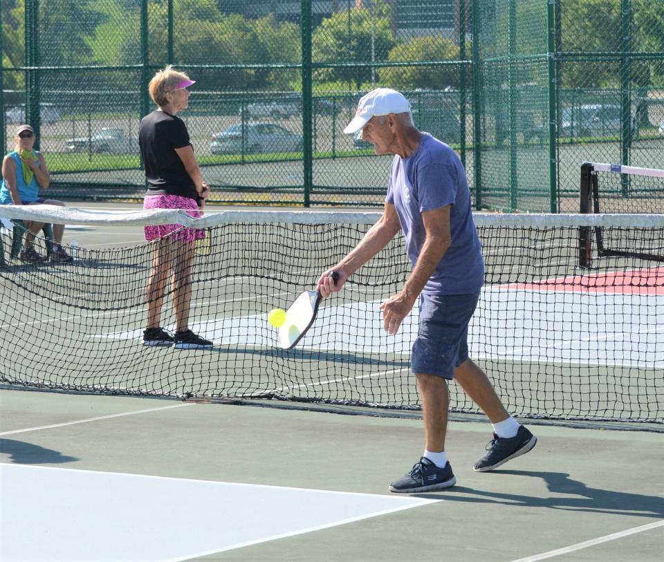Donald Bouchard serves during a match. The Battle Creek Pickleball Club plays several times a week at the refurbished courts at Kellogg Community College.