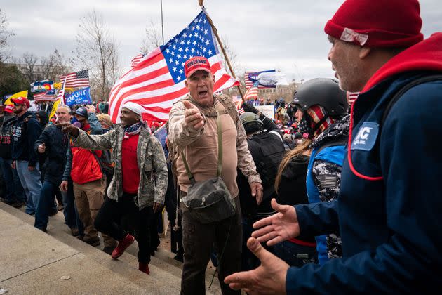 Ray Epps, in the red Trump hat, center, gestures to others as people gather on the West Front of the U.S. Capitol on Jan. 6, 2021, in Washington, D.C.