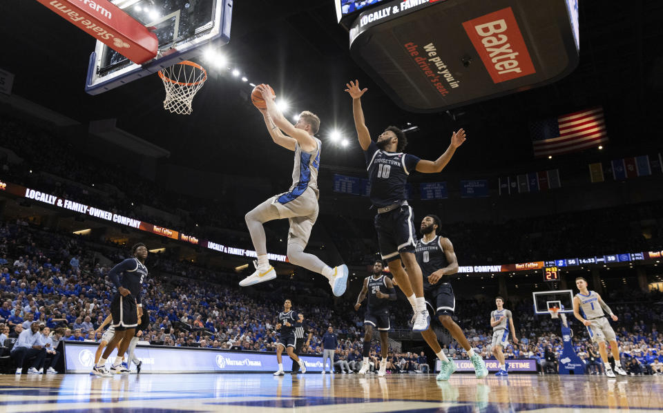 Creighton's Baylor Scheierman, left, shoots against Georgetown's Jayden Epps (10) during the second half of an NCAA college basketball game Tuesday, Feb. 13, 2024, in Omaha, Neb. (AP Photo/Rebecca S. Gratz)