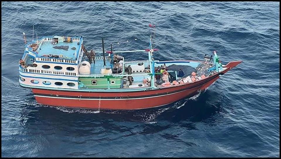 a multicolored ship sailing in the sea with packages onboard