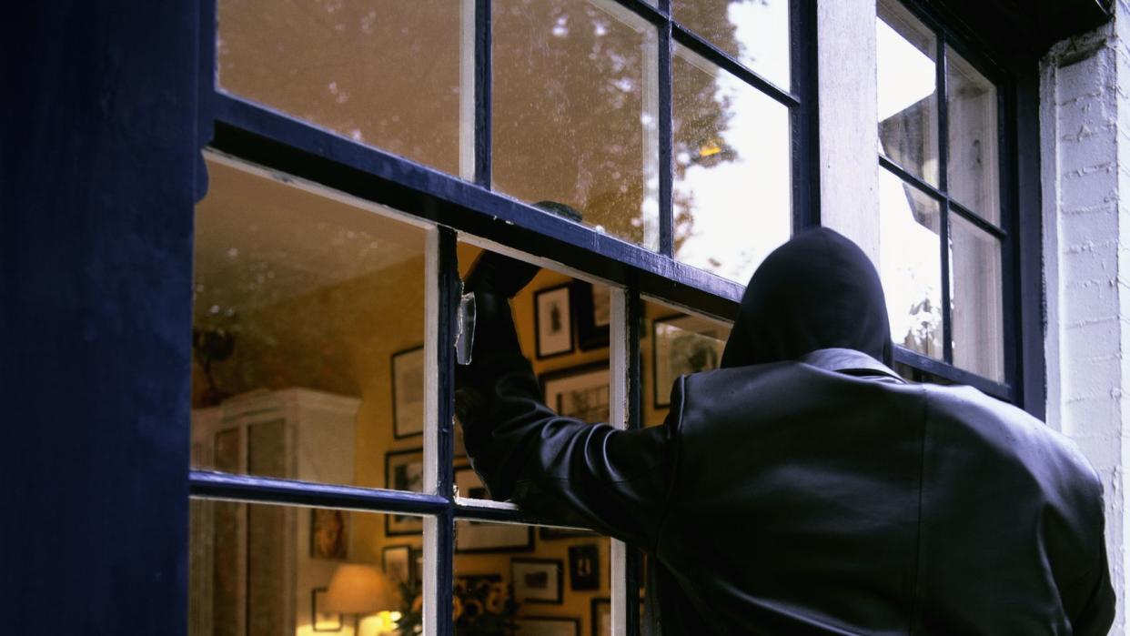 burglar smashing through window
