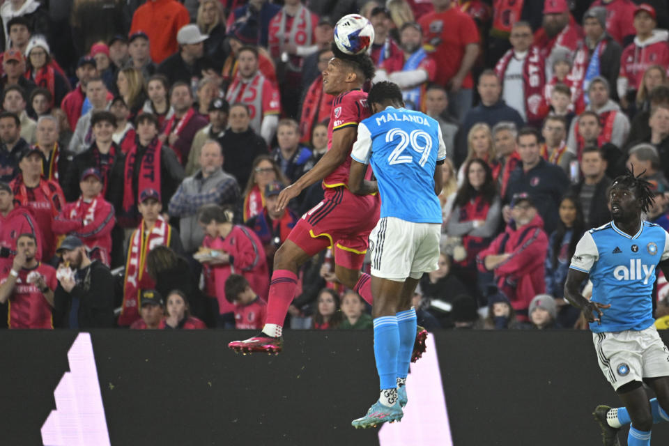 St. Louis City SC midfielder Njabulo Blom (6) and Charlotte FC defender Adilson Malanda (29) jump for a header during the first half of an MLS soccer match Saturday, March 4, 2023, in St. Louis. (AP Photo/Joe Puetz)