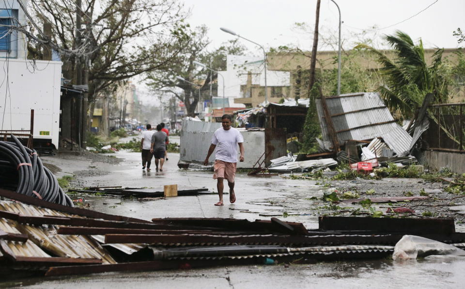 <p>In this Saturday, Sept. 15, 2018, file photo, a resident walks beside toppled structures as Typhoon Mangkhut barreled across Tuguegarao city in Cagayan province, northeastern Philippines.<br>(Photo by Aaron Favila, AP) </p>