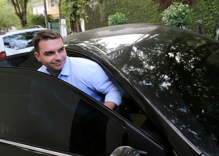 FILE PHOTO: Flavio Bolsonaro, son of Brazil's President-elect Jair Bolsonaro, gets into a car after a meeting with his father, in Rio de Janeiro, Brazil October 30, 2018. REUTERS/Sergio Moraes/File Photo