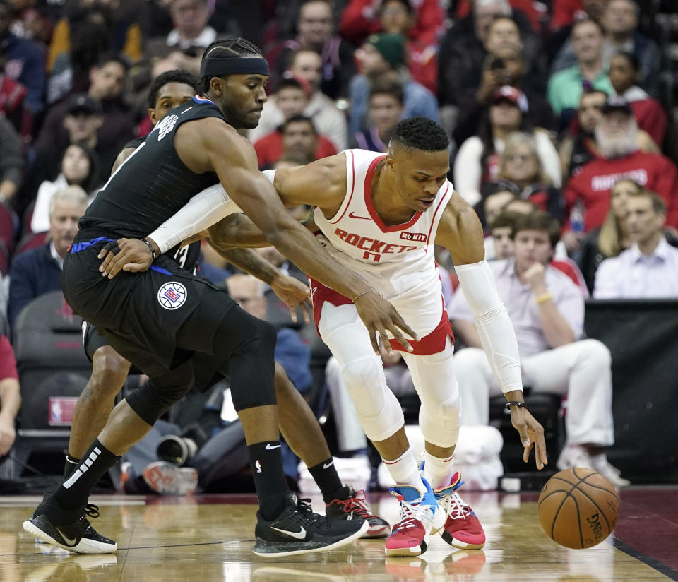 Houston Rockets' Russell Westbrook (0) keeps the ball from LA Clippers' Maurice Harkless during the first half of an NBA basketball game Wednesday, Nov. 13, 2019, in Houston. (AP Photo/David J. Phillip)