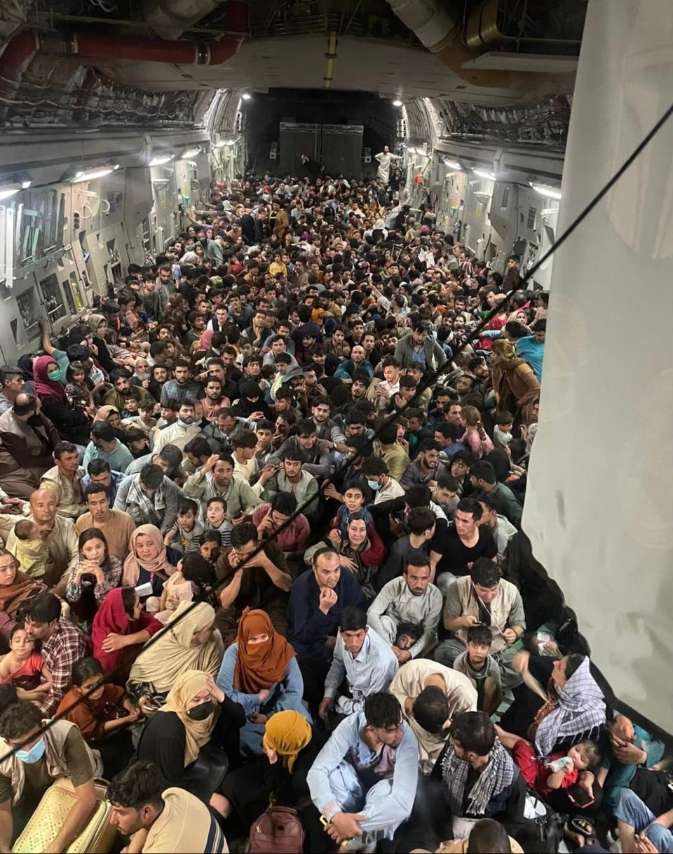 A photo provided courtesy of Defense One shows the inside of Reach 871, a U.S. Air Force C-17 cargo plane flown from Kabul to Qatar on Aug. 15, 2021. A defense official told Defense One that approximately 640 Afghan civilians were on board the flight.