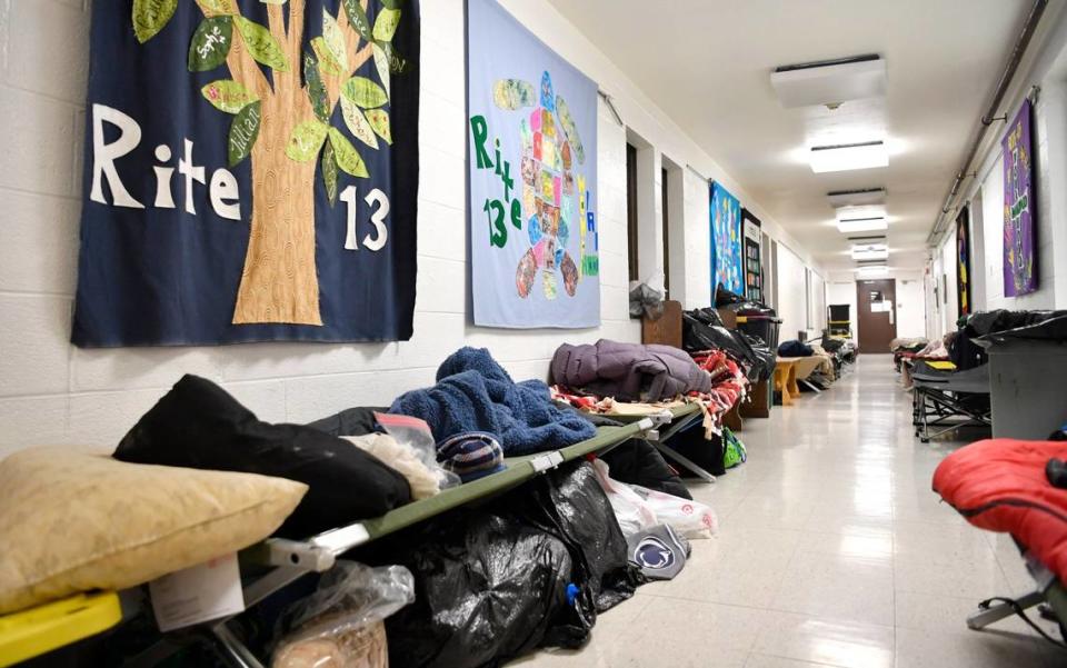 Cots and belongings line a hallway at St. Andrew’s church on Nov. 26, 2019. Point-in-Time counts in Centre County have shown a high number of sheltered or unsheltered homeless in the area.