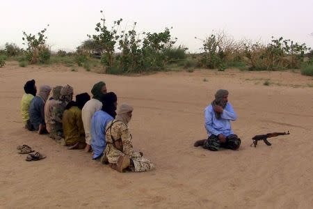 The leader of the Coordination of Azawad Movements (CMA), Mohamed Ag Najim (R), leads his men in prayer outside Anefis, Mali, August 26, 2015. The United Nations has deployed 10,000 peacekeepers and poured more than $1 billion into Mali but its efforts to end a three-year conflict are threatened by the reemergence of a centuries-old rivalry between Tuareg clans. Picture taken August 26. To match Insight MALI-VIOLENCE/MILITIA REUTERS/Souleymane Ag Anara