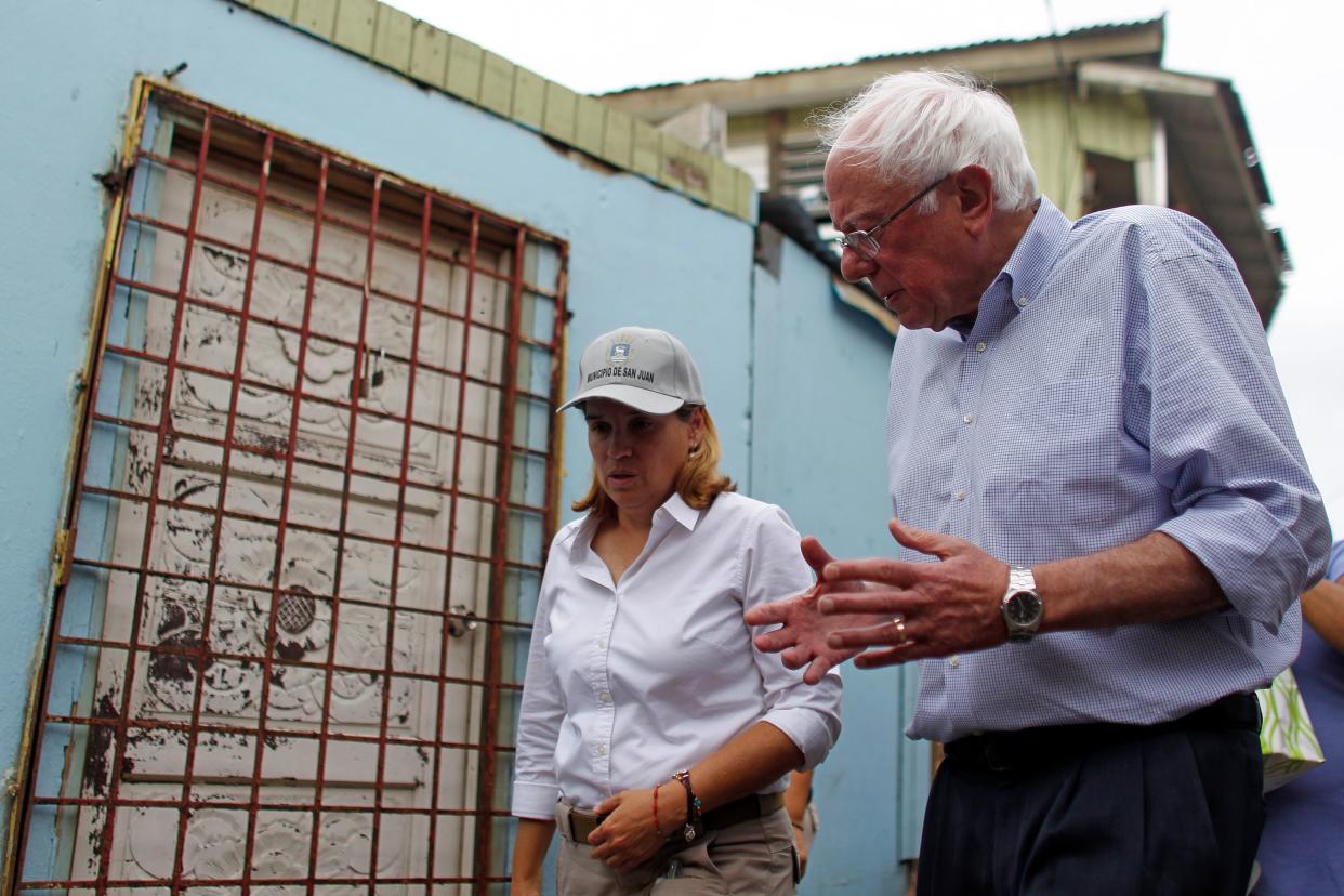 Sen. Bernie Sanders (I- Vt.) talks to the Mayor of San Juan, Carmen Yulin Cruz during a visit to the Playita community in San Juan, Puerto Rico, on October 27, 2017.&nbsp; (Photo: RICARDO ARDUENGO/AFP/Getty Images)