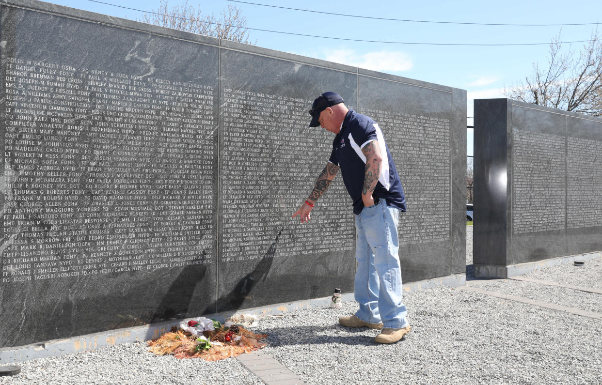 John Feal points out the name of his friend, FDNY F.F. Ray Pfeifer, on the 9/11 Responders Remembered Park in Nesconset, April 6, 2021. Feal, who established the FealGood Foundation and created the park, has become a leading activist in getting the 9/11 James Zadroga Act, the WTC Health Program and the 9/11 Victims Compensation Fund, passed and then renewed and then made permanent.