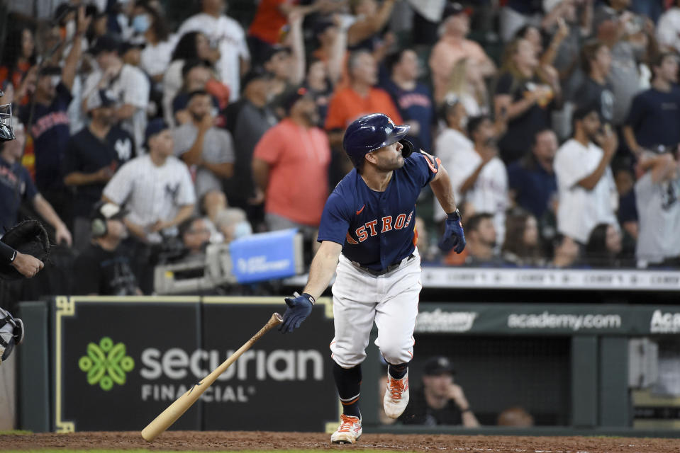 Houston Astros' Jose Altuve watches his game-winning three-run home run during the ninth inning of a baseball game against the New York Yankees, Sunday, July 11, 2021, in Houston. (AP Photo/Eric Christian Smith)