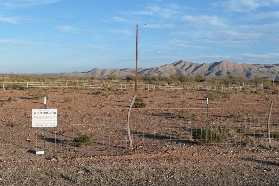 The proposed route of the Saguaro pipeline passes close to this property south of Van Horn. A sign in opposition to the pipeline is attached to the fence.